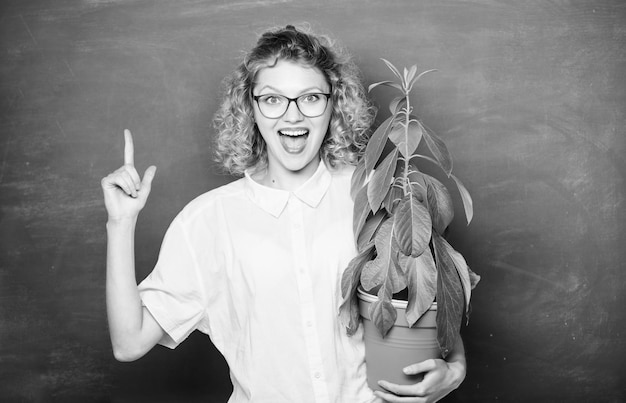 Photo environmental education happy student girl with plant at blackboard teacher woman in glasses at biology lesson school nature study tree of knowledge school learning ecology transplant flowers