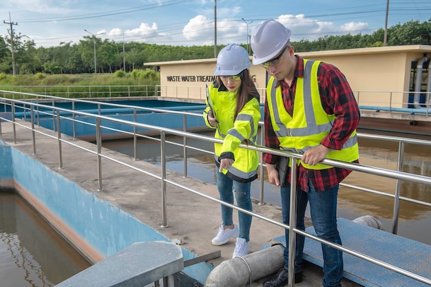 Environmental engineers work at wastewater treatment plantsWater supply engineering working at Water recycling plant for reuseTechnicians and engineers discuss work together