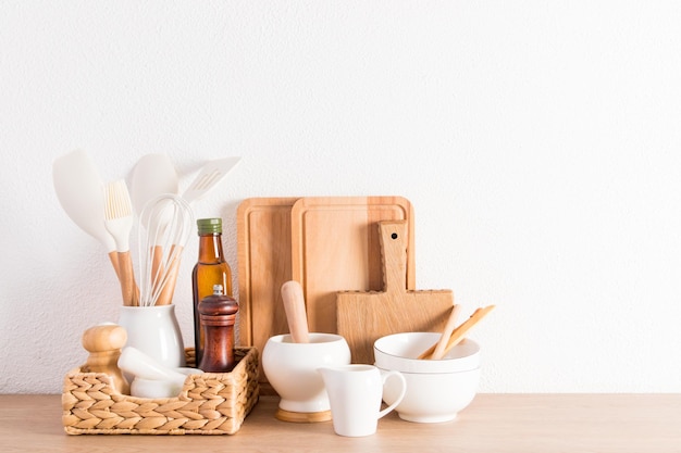 Environmentally friendly items of modern utensils on a kitchen wooden countertop near a white textured wall ecofriendly materials without plastic