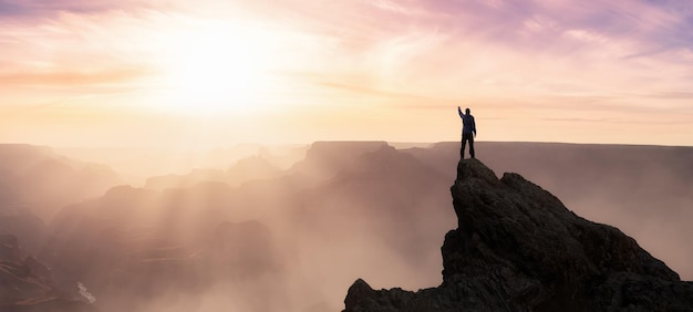 Epic Adventure Composite of Man Hiker on top of a rocky mountain