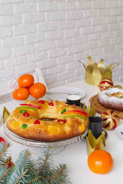 Epiphany day dessert on the table with fruit and crown