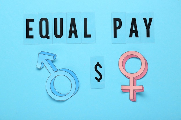 Photo equal pay concept gender symbols on light blue background flat lay