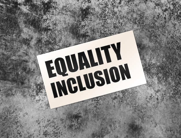 Equality Inclusion words on card on grey background Business concept