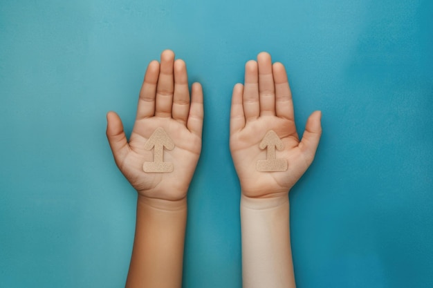 Equality symbol in childs hands on blue background promoting equal rights