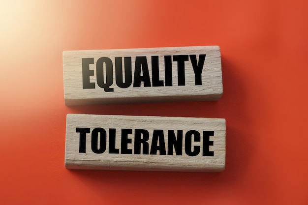 Equality and tolerance words on wooden blocks on red