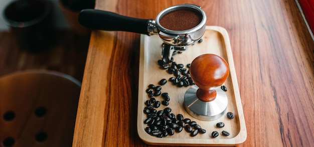 Equipment of barista coffee tool tamper and tempered coffee in portafilter roasted coffee beans