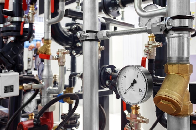 Equipment of the boiler room  valves, tubes, pressure gauges, thermometer. Close up of manometer of heating system