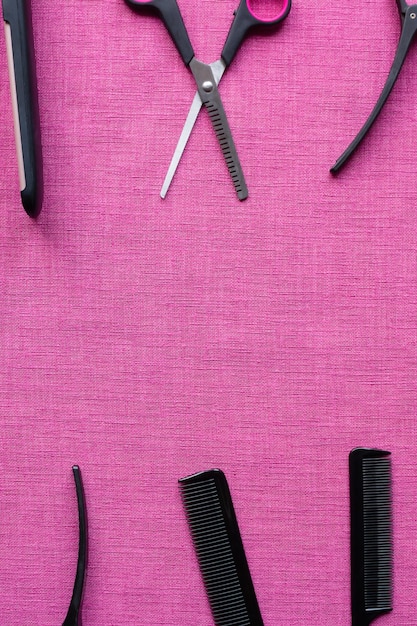 Equipment for hairdresser on pink background and space for text