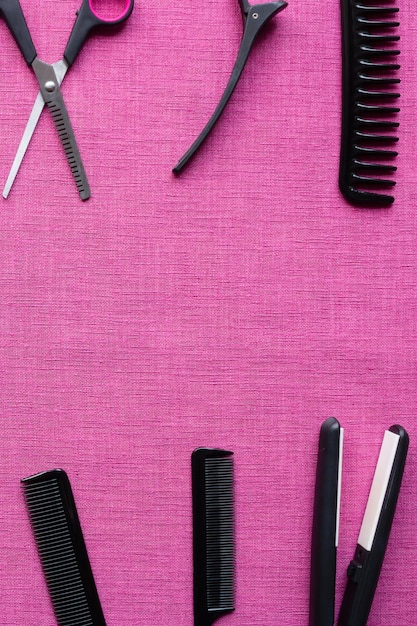 Equipment for hairdresser on pink background and space for text