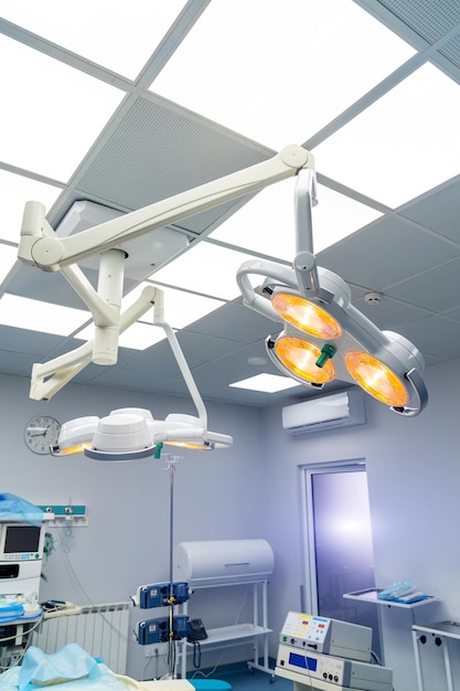 Equipment and medical devices in modern operating room take with art lighting. Surgery room in modern hospital.