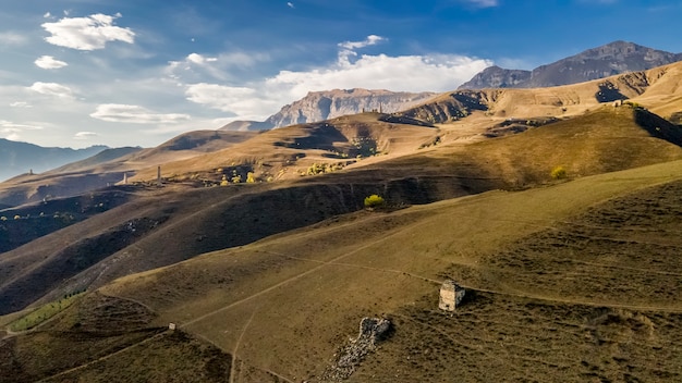 Erzi towers complex Impressive rocky wall of the Caucasus mountains is on the background Aerial view