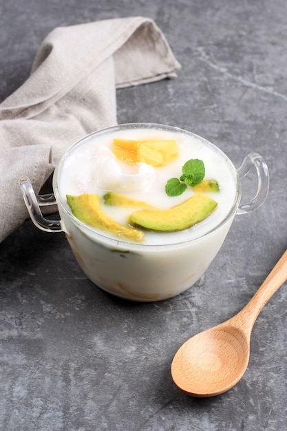 Es Teler, Traditional Indonesian Ice Dessert of Tropical Fruit Cocktail (Avocado, Jackfruit) in Sweet Coconut Water and Condensed Milk. Served in a Bowl with Copy Space