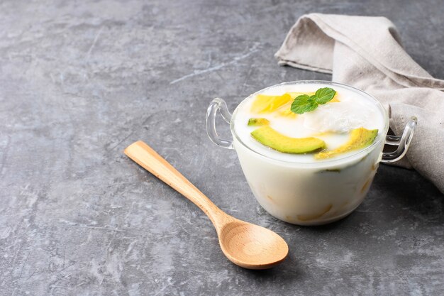 Es Teler, Traditional Indonesian Ice Dessert of Tropical Fruit Cocktail in Sweet Coconut Water and Condensed Milk Served in a Bowl