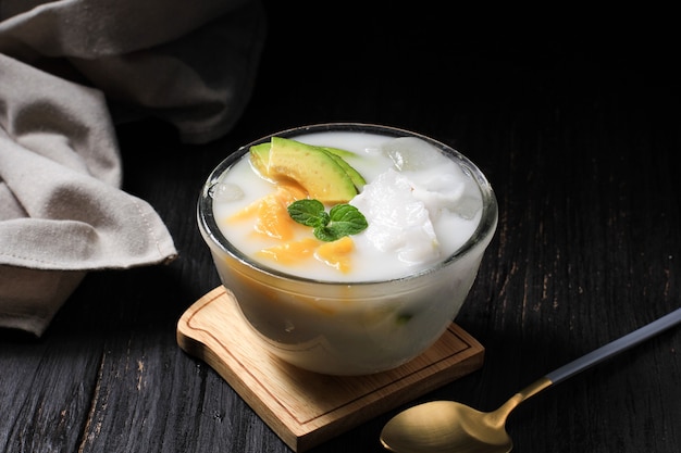 Es Teler, Traditional Indonesian Ice Dessert of Tropical Fruit Cocktail in Sweet Coconut Water and Condensed Milk Served in Bowl