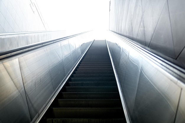 Escalator leads somewhere to a bright light