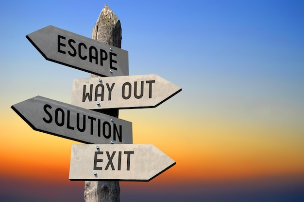 Escape way out solution exit wooden signpost