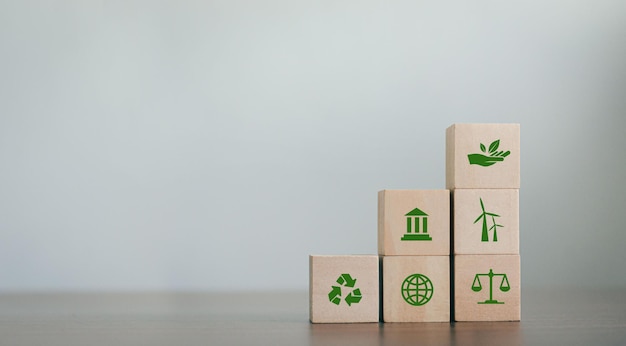 ESG Concepts on Environment Society and Governance Revolving Sustainable Organization Development Wooden block with environmental ESG icon on gray background copy space