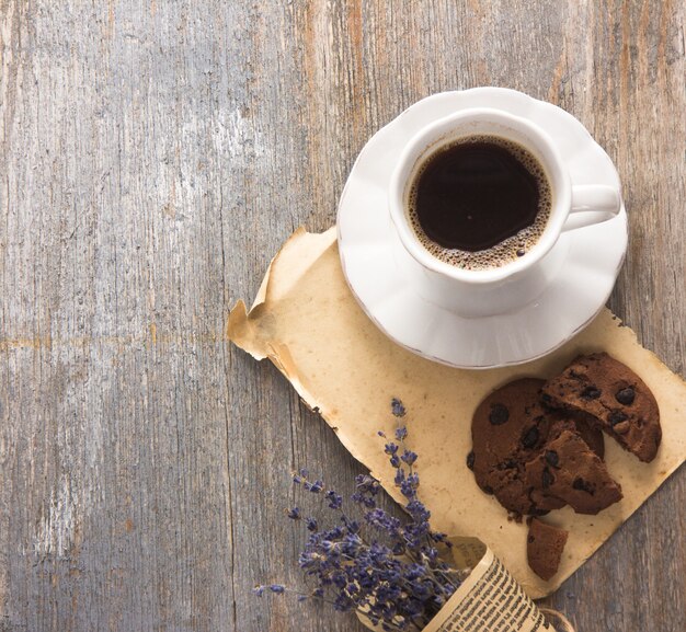 Espresso coffee cup with book on table.