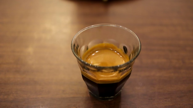 Espresso coffee in a small glass at the table