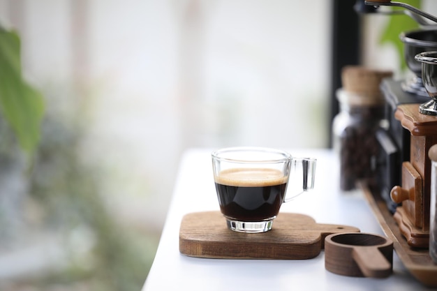 Espresso glass cup on wooden tray