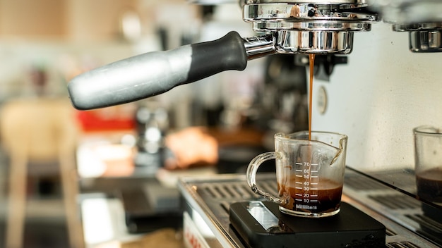 Espresso machine making espresso coffee in coffee shop