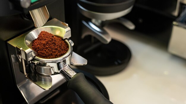 Photo espresso machine with ground coffee ready to make a drink