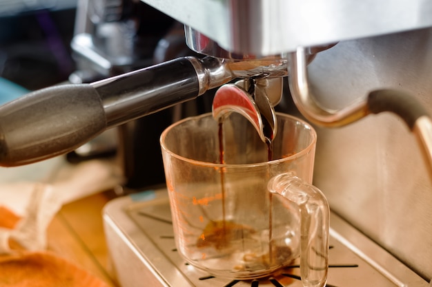 espresso pouring from coffee machine 