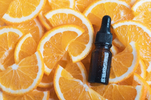 Essential aroma oil or serum essence with fresh orange citrus fruits