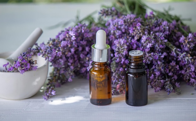 Essential oil of lavender on a wooden background