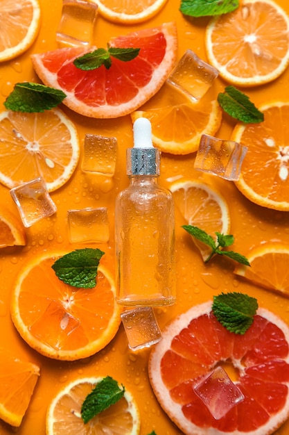 Essential oil of orange on a yellow background Selective focus