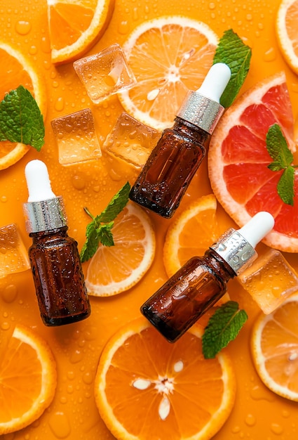 Essential oil of orange on a yellow background Selective focus