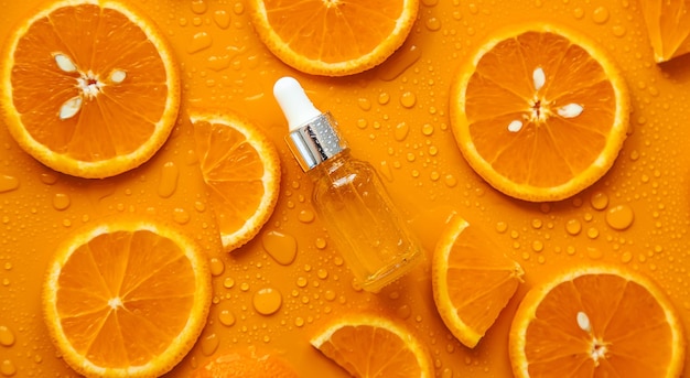 Essential oil of orange on a yellow background Selective focus