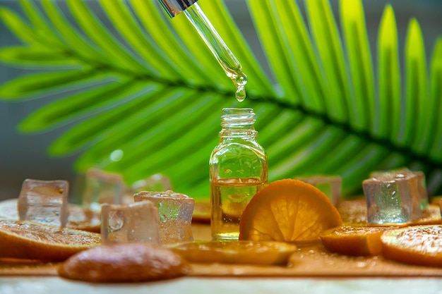 Essential oil of orange on a yellow background Selective focus