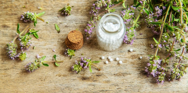 Essential oil of thyme in a bottle Selective focus