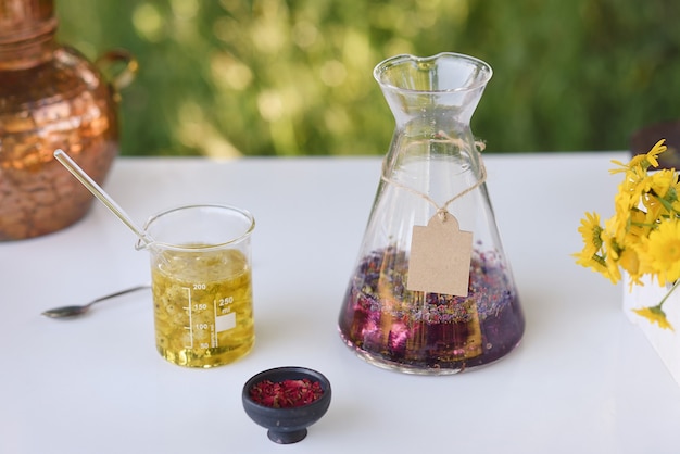 Essential oils with flowers in an open air laboratory