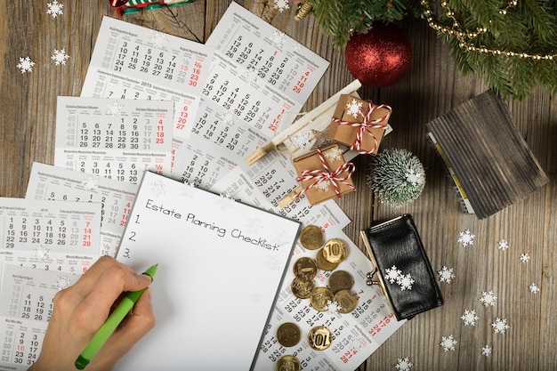 Photo estate planning checklist. small purse with coins on the new year's background. top view