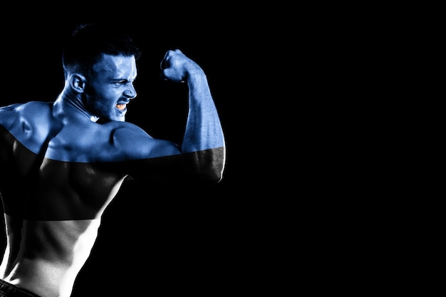 Estonia flag on handsome young muscular man black background