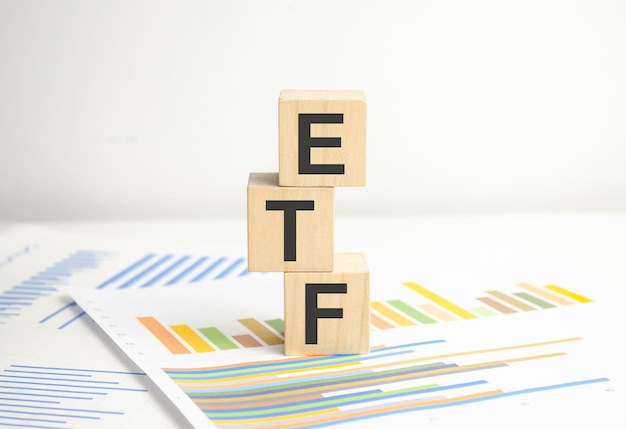 ETF word written on wood block on chart background