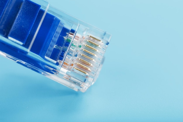 Ethernet Cable connector Patch cord cord closeup on a blue background with free space