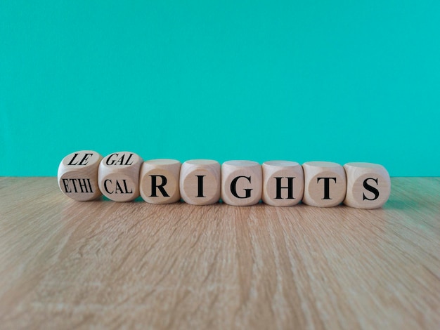 Photo ethical or legal rights symbol turned wooden cubes and changes words ethical rights to legal rights