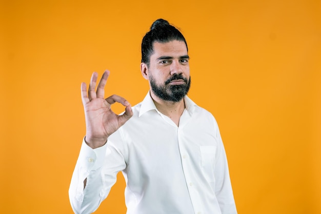 Ethnic male entrepreneur gesturing okay