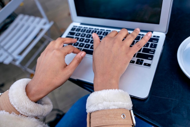 Ethnic young woman watching online education webinar using laptop