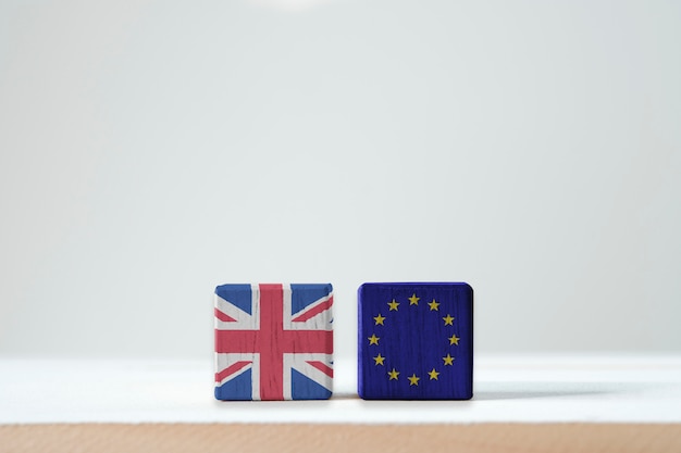 EU flag and British flag print screen on wooden cubic. It is symbol of British need to exit or call BREXIT from European Union members zone.