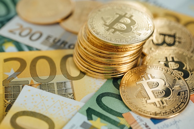 Euro Banknotes and Bitcoin cryptocurrency investing concept. Euro Money and Crypto currency golden bitcoin coin.