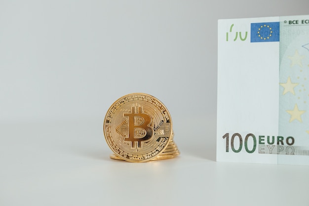 Euro Banknotes and Bitcoin cryptocurrency investing concept. Euro Money and Crypto currency golden bitcoin coin.