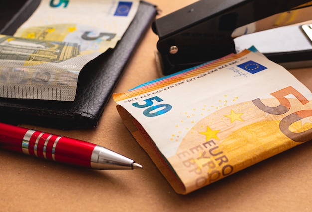 euro banknotes on a brown paper envelope in an office environment