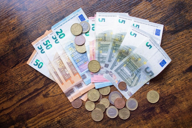 Euro banknotes and coins are on the table