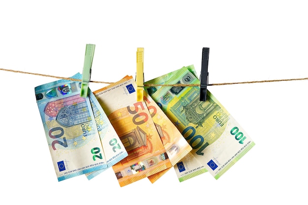 Euro banknotes hanging on a clothesline against white background Money laundering concept