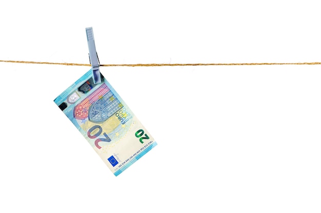 Euro banknotes hanging on a clothesline against white background Money laundering concept