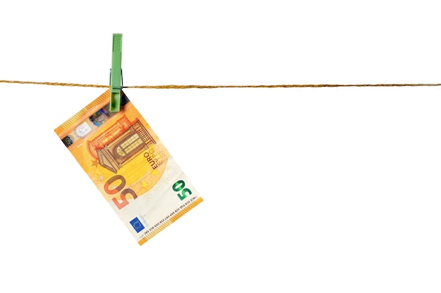 Euro banknotes hanging on a clothesline against white background Money laundering concept